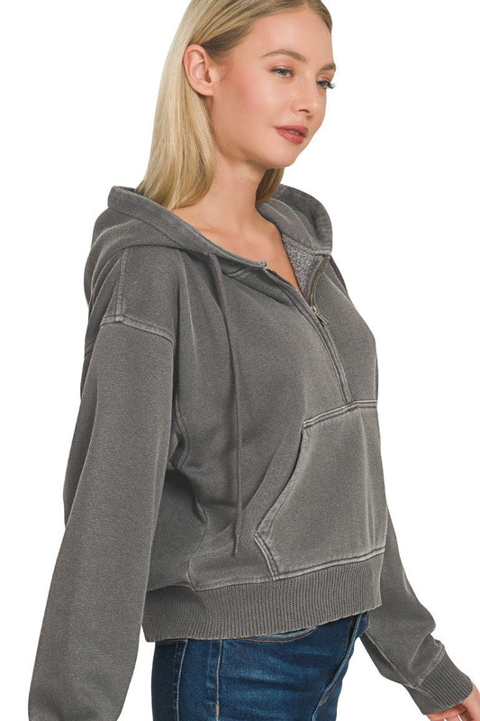 Woman wearing an ash black hoodie on a white background