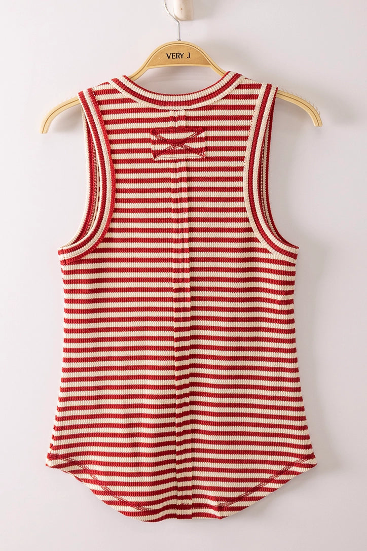 Red and white striped tank top on a wooden hanger against a white background