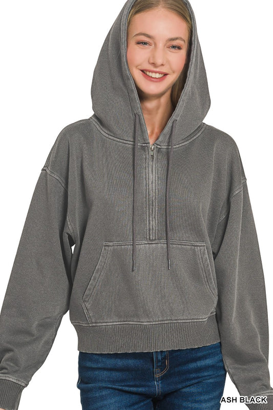 Person wearing a gray hoodie on a white background