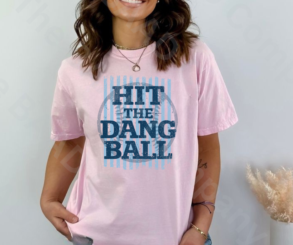 Person wearing a pink t-shirt with 'Hit the Dang Ball' text design.